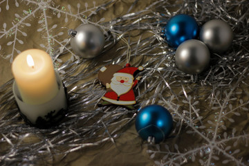 a white candle stands on a grey background with festive decorations (Christmas, new year)