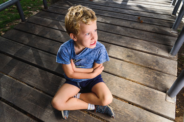 Portrait of 6 year old boy with expression on his face in anger and surprise.