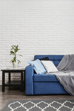 Blue Couch With Pillows And Grey Plaid