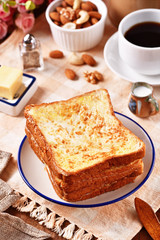 Golden brown french toasts on white plate.  