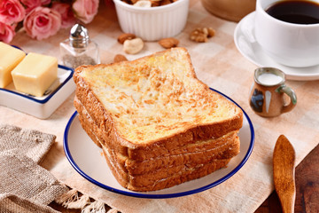 Golden brown french toasts on white plate.  