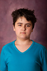 Fototapeta premium Portrait of a teenager boy in a blue T-shirt
