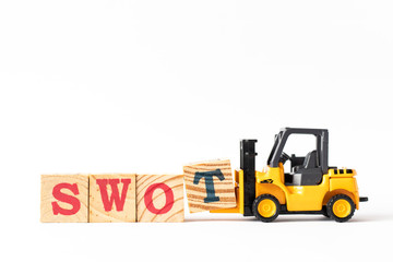 Toy forklift hold wood letter block t to complete word swot (abbreviation of strength, weakness, opportunities, threats) on white background
