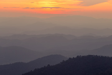The blurred natural background of colorful twilight in the evening, on the high mountains, with many forests, provide fresh air and preserve the ecology.