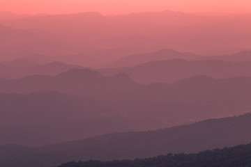 The blurred natural background of colorful twilight in the evening, on the high mountains, with many forests, provide fresh air and preserve the ecology.