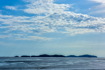 In summer, beautiful coastline and island scenery in cloudy background.