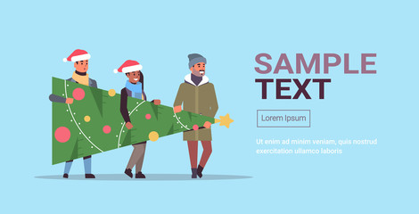 people carrying fir tree preparing for merry christmas happy new year holiday celebration concept mix race friends wearing santa hats copy space horizontal full length vector illustration