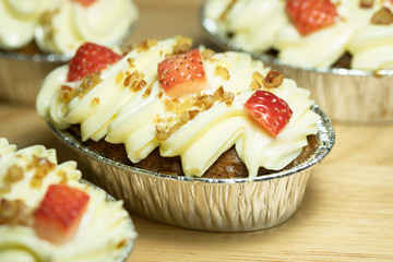 Carrot cake decorated with strawberries and butter peas