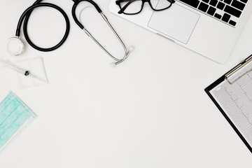 Stethoscope, Top view of doctor's desk table, blank paper on white background, above view doctor work tools on white, Stethoscope, laptop, eyeglass and medical drug on white background, 