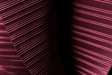 Pleat Fabric in long line drape with shadow, pleated style of textile pattern in red burgundy color put in layer design wave wallpaper, studio lighting close up background image