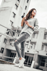 Beautiful girl posing in the street. Urban style. Street fashion.