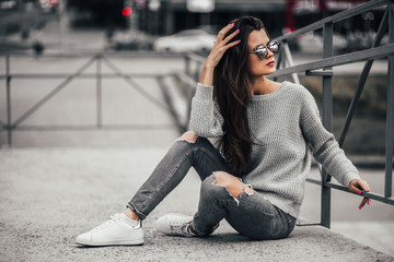 Beautiful girl posing in the street. Urban style. Street fashion.
