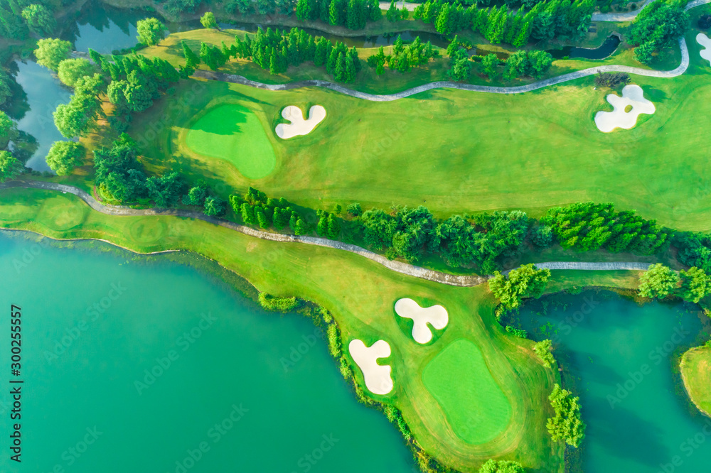 Wall mural aerial view of golf course and water