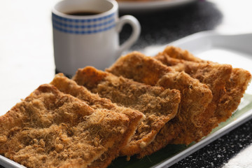 Rice cracker with flossy pork and beverage for background.