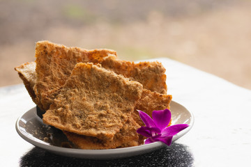 Rice cracker with flossy pork and beverage for background.