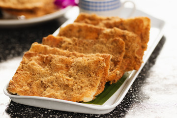 Rice cracker with flossy pork and beverage for background.