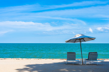 Beautiful umbrella and chair around beach sea ocean with blue sky for travel