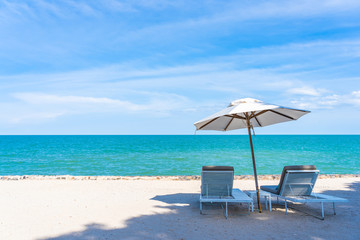 Beautiful umbrella and chair around beach sea ocean with blue sky for travel