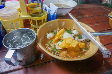 Bangkok, Thailand, 6 September 2019: Noodles with pork ball and pork. A glass of stainless steel in a noodle shop.
