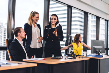 Group of professional business meeting and discussing strategy with new startup project.Creative business people planning and brainstorm with document report in modern workloft.Teamwork concept