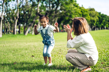 Fototapeta premium Portrait of happy grandmother and little cute girl enjoy relax together in summer park.Family and togetherness