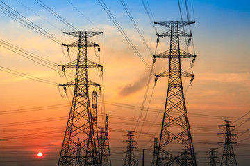 Fototapeta premium Electricity tower silhouette and sky landscape at dusk