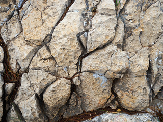 Cracked aged mountain hard rock stones