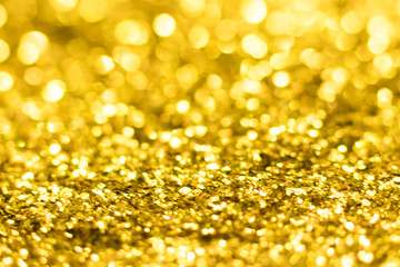 Gold glitter texture. Festive sparkling sequins background. Wpaper for Valentine, New Year or Christmas Holidays.