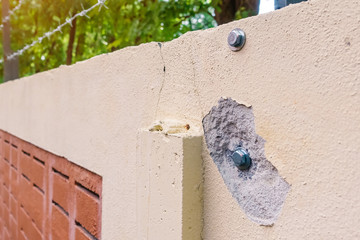 Broken on concrete walls after drilling and fixing bolt with nut and washer.