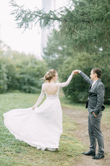 Modern ceremony in European style. Beautiful wedding couple in atmospheric forest with rocks.