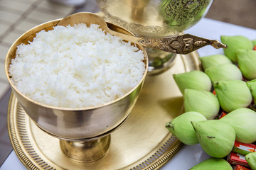 Rice in gold bowl  and green lotus prepare for give alms food to Buddhist monk