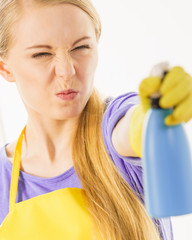 Girl cleaning window at home