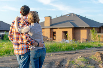 loving couple looking at their home