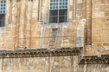 Immovable ladder in front of a window of the church of the holy sepulchre in Jerusalem, Israel