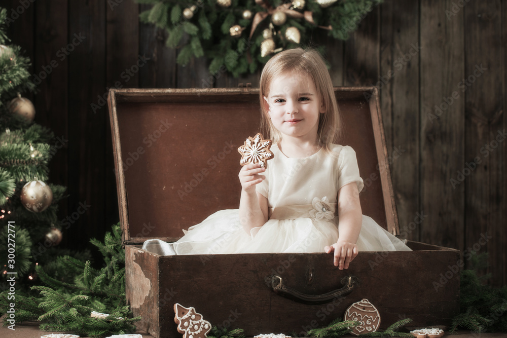 Wall mural  little girl in dress with christmas tree in retro style