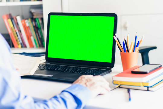 Close-up Of Hand Man Using A Mouse And Typing On Green Screen Laptop On White Table, Business Concept.