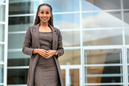 Modern Portrait Of African American Female Business Person Standing By Office Building, Architecture Firm, Law, Finance Or Other Professional Occupations