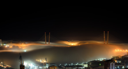 Fototapeta premium Vladivostok cityscape night view. Fog over the city.