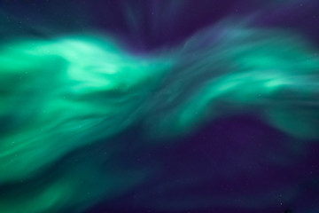Shape of fast moving northern lights. Looking up in the sky. Green aurora borealis in dark blue sky.. Tromso, Norway.