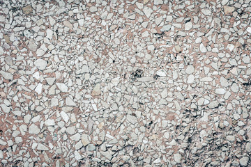 stone texture of an old sidewalk made of small pieces of granite.