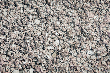 stone texture of an old sidewalk made of small pieces of granite.
