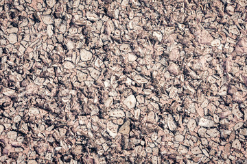 stone texture of an old sidewalk made of small pieces of granite.