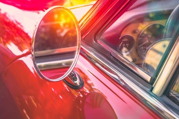 Side mirror of a vintage red car