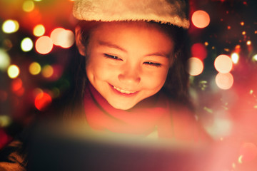 closeup smiling  little girl watching the christmas presents.