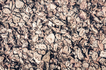 stone texture of an old sidewalk made of small pieces of granite.