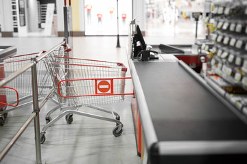 Empty cash desk with closed way border in supermarket