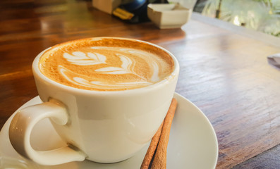 cup of coffee on wooden background