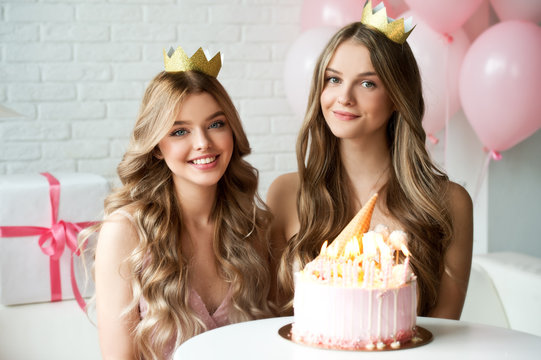 Happy female friends at a party in honor of the birthday! Sixteenth birthday. Girlfriends eat Birthday cake.