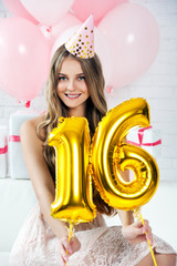 Happy pretty girl with cream cake and pink balloons at birthday party.  Barbie style. Princess.  16...