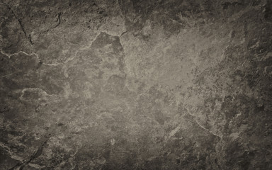 Brown and black background with vintage grunge texture, old textured stone or rock wall 